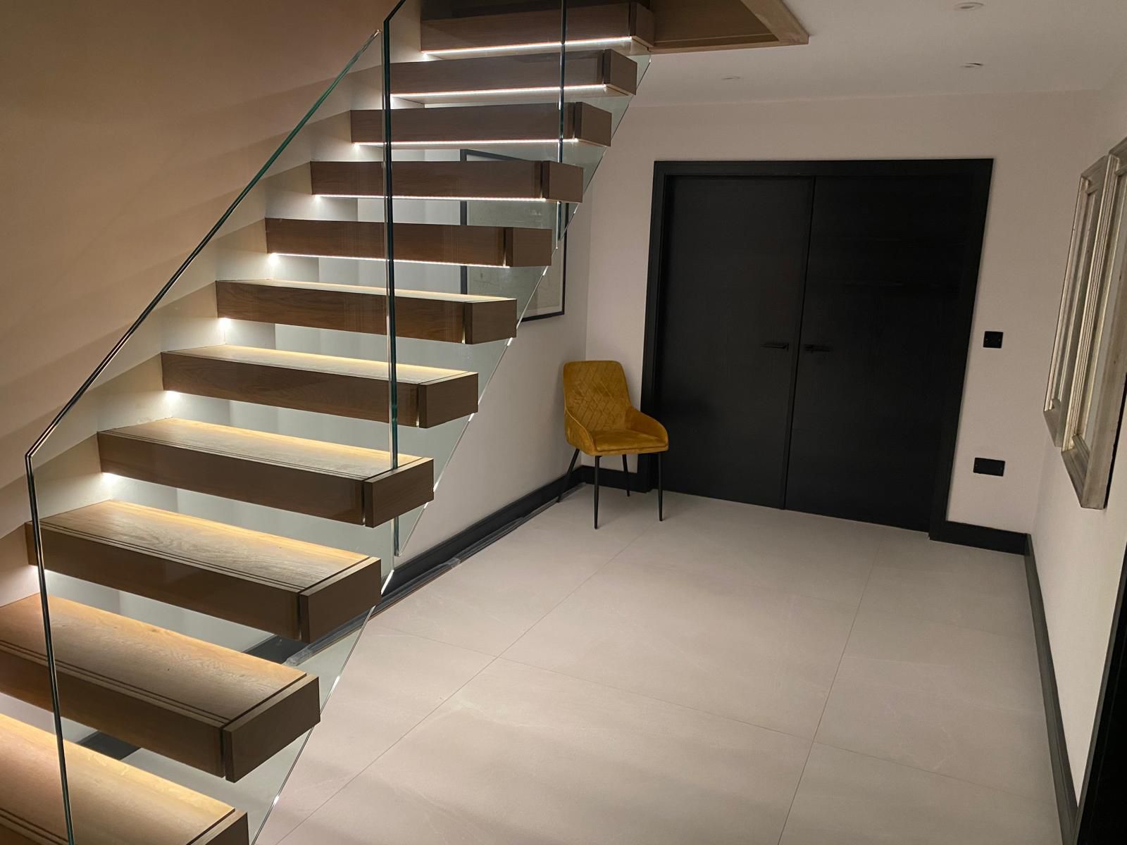 Floating oak and glass staircase with under-tread LED lighting